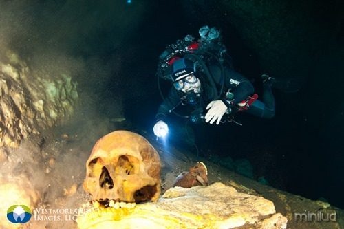 Team divers inspecting and filming Mayan remains of sacrifices in San Antonio Cenote